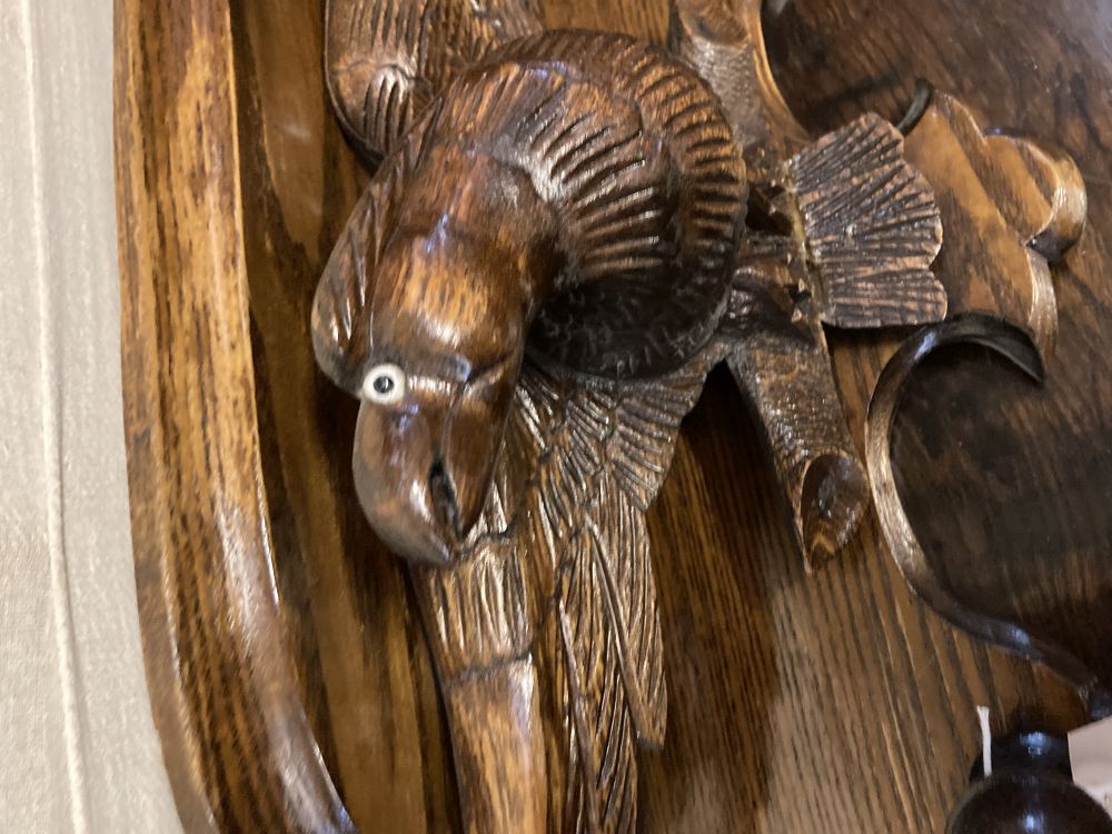 A carved oak eagle hanging coat rack, width 60cm, together with a carved walnut corbel, height 26cm